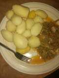 Boil Irish potatoes with garden egg sauce