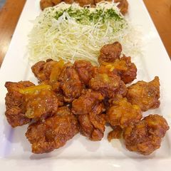 A picture of Crispy chicken nuggets with sweet and sour orange glaze.