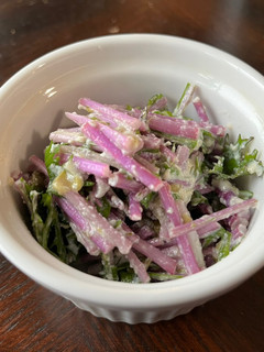 A picture of Mizuna salad with tofu Caesar dressing.