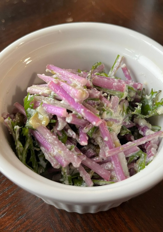 A picture of Mizuna salad with tofu Caesar dressing.