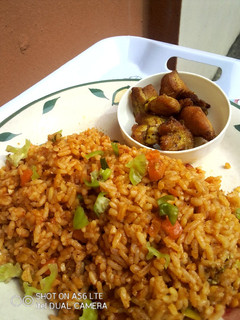 A picture of OrangeGreen Jollof Rice.
