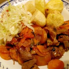 A picture of Mutton stew with deep fried potatoes.