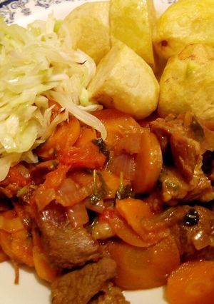 A picture of Mutton stew with deep fried potatoes.