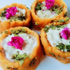 A picture of Ladoo cups with Rabri filling busicuits crums.