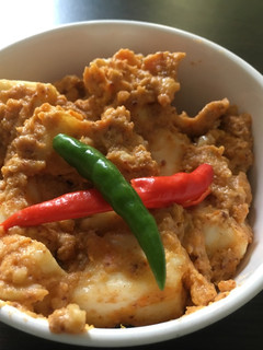 A picture of Steamed paneer in tomato and cashew paste (100% oil free).