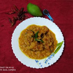 A picture of Rohu fish with raw mango.