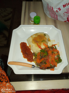 A picture of Couscous and shredded beef sauce with stew.