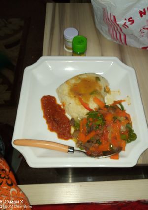 A picture of Couscous and shredded beef sauce with stew.