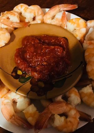 A picture of Some shrimps with tomato sauce.