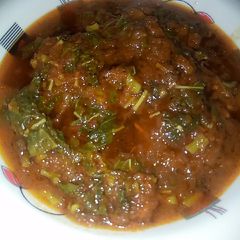 A picture of Pumpkin soup with spinach.