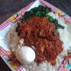 A picture of White rice with tomato sauce and vegetable.