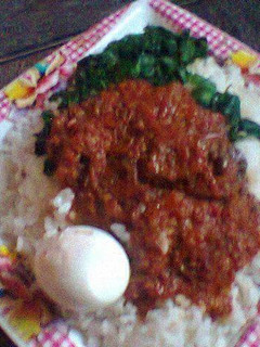 A picture of White rice with tomato sauce and vegetable.