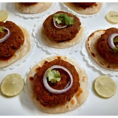 A picture of Mutton Shami Kebab with Mini Paratha and Yoghurt dip.