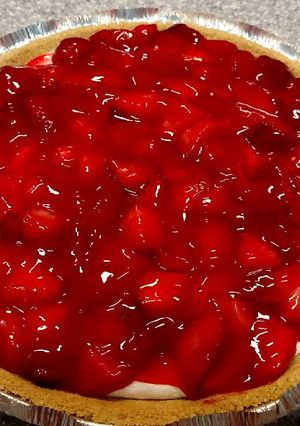 A picture of Cream cheese pie with strawberry topping.
