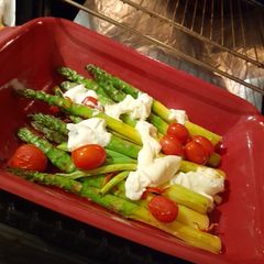 A picture of Asparagus with burrata in the oven.