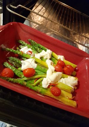 A picture of Asparagus with burrata in the oven.