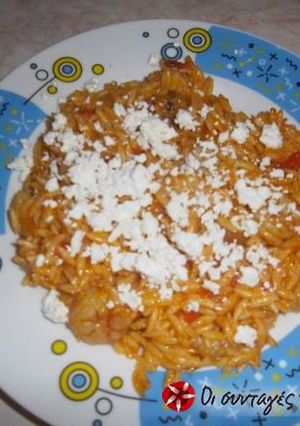 A picture of Shrimps with orzo, ouzo and feta cheese.