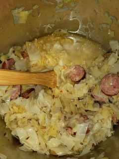 A picture of Cabbage and sausage with sauerkraut.