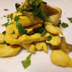A picture of Chicken and porcini mushrooms in a saffron and white wine sauce.