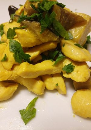 A picture of Chicken and porcini mushrooms in a saffron and white wine sauce.