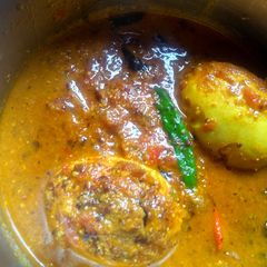 A picture of Egg curry with mustard seeds and poppy seeds paste.