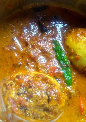A picture of Egg curry with mustard seeds and poppy seeds paste.