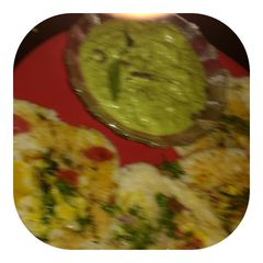 A picture of Coconut green chutney with uttapam (mix veg).