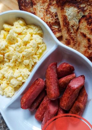 A picture of Homemade french toast, scrambled eggs and sausages.