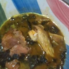 A picture of Bitter leaf soup with beef and smoked fish.