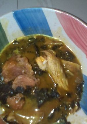 A picture of Bitter leaf soup with beef and smoked fish.