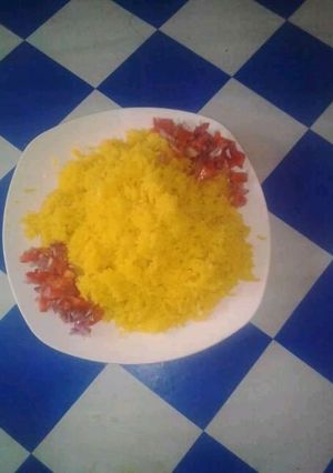 A picture of Tumeric Rice with kachumbari Salt.