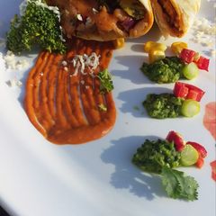 Burrito with pea guacamole & marinara sauce A picture of Burrito with pea guacamole & marinara sauce.