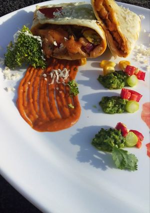 A picture of Burrito with pea guacamole & marinara sauce.