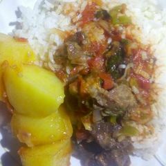 A picture of Rice and beef stew with irish potato.