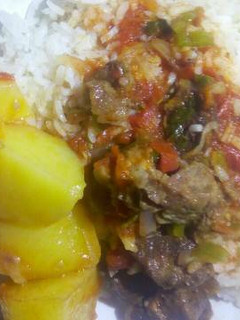 A picture of Rice and beef stew with irish potato.