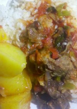 A picture of Rice and beef stew with irish potato.