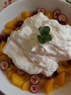 Una foto de Melocotones y arándanos frescos con espuma de nata