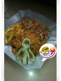 A picture of Jollof rice with Irish and scramble egg.