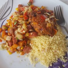 A picture of Couscous with sausage stir fry and BBQ turkey.