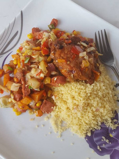 A picture of Couscous with sausage stir fry and BBQ turkey.