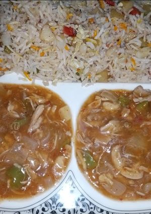 A picture of Veg Fried rice with chili chicken sauce.