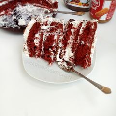 A picture of Red velvet cake with whipped cream frosting.