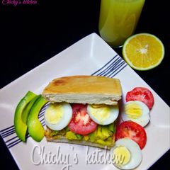 A picture of Avocado, tomato and egg sandwich.