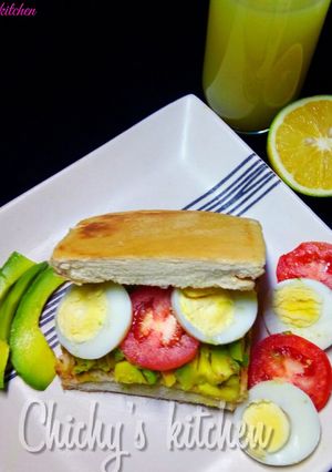 A picture of Avocado, tomato and egg sandwich.