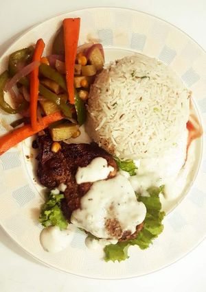 A picture of Teragon steaks with garlic rice and vegs.