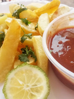 A picture of Potato wedges with tamarind chutney.