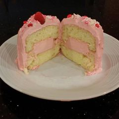 A picture of Vanilla Butter Cakes filled and Frosted with Whipped White Chocolate Rasberry Ganache.
