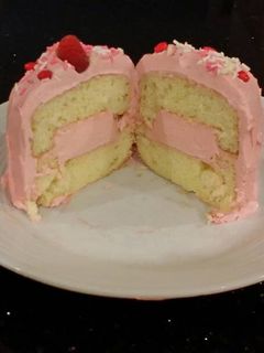A picture of Vanilla Butter Cakes filled and Frosted with Whipped White Chocolate Rasberry Ganache.