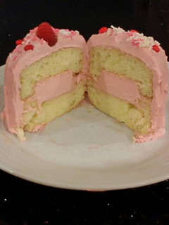 A picture of Vanilla Butter Cakes filled and Frosted with Whipped White Chocolate Rasberry Ganache.