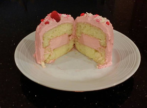 A picture of Vanilla Butter Cakes filled and Frosted with Whipped White Chocolate Rasberry Ganache.
